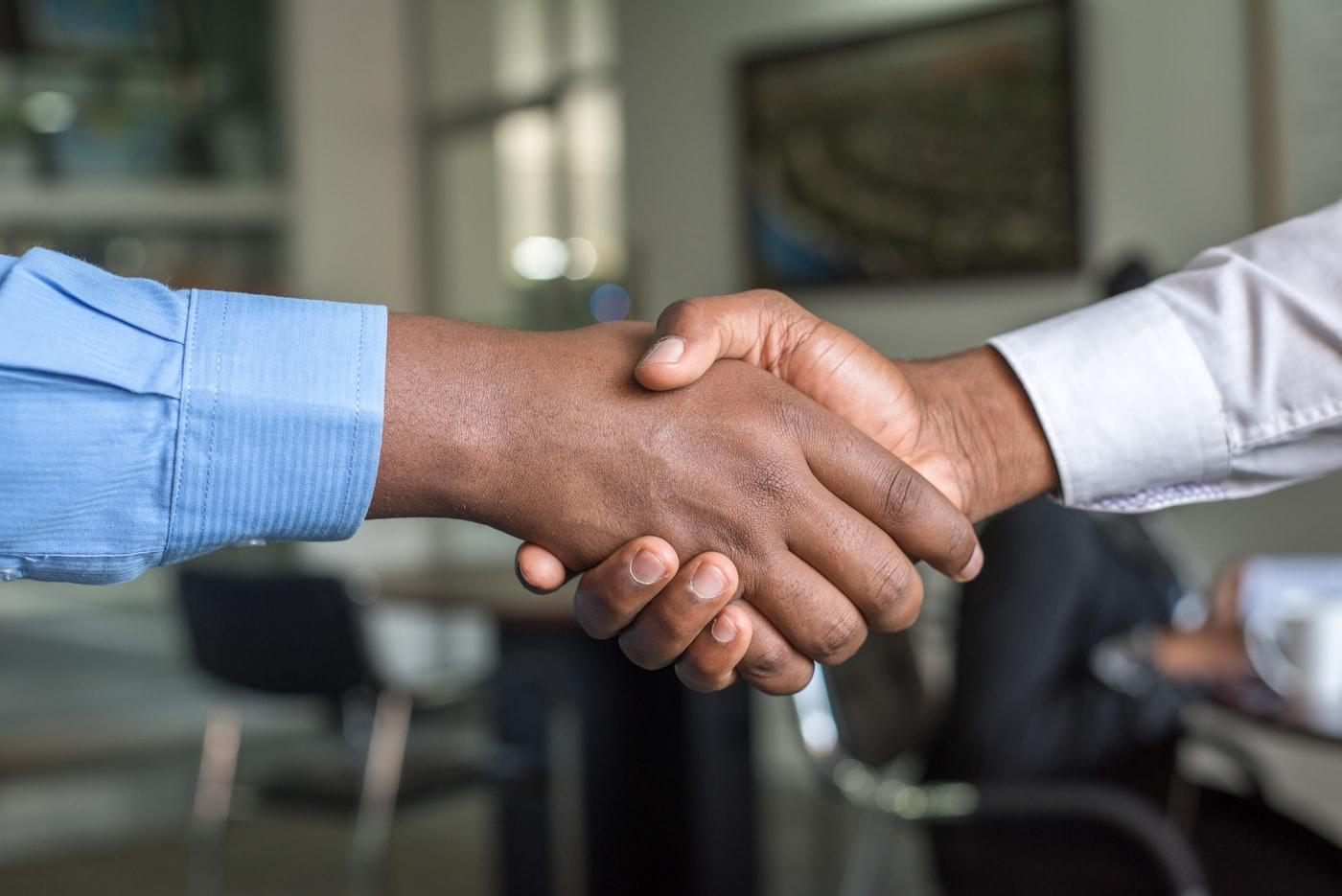 An accountant shaking hands with a client after a consultation